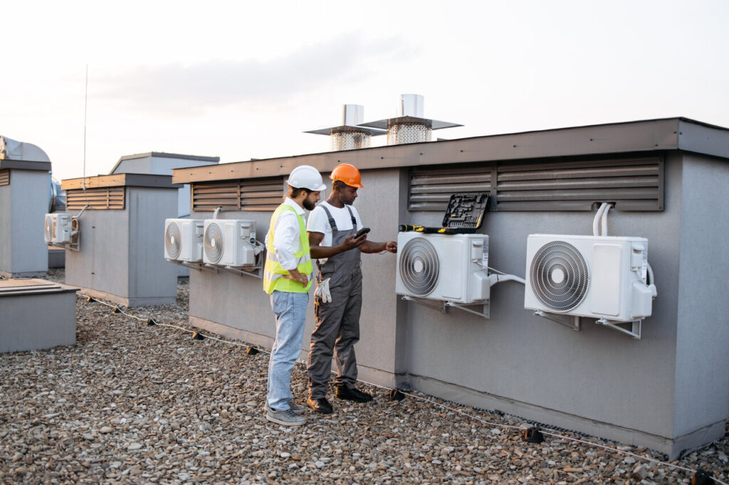 rsz two construction workers on roof inspecting coolin 2023 12 21 22 01 44 utc